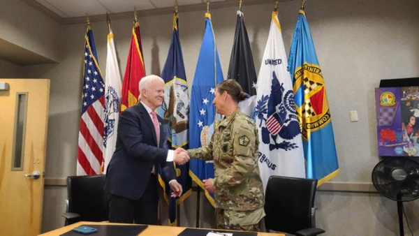 Dr. Michael Jordan shakes hands with Colonel Megan B. Stallings