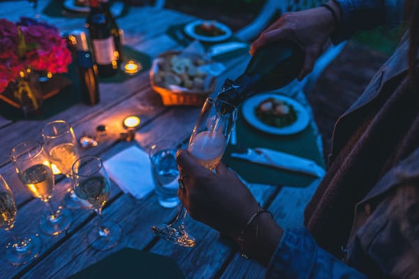 Pouring a glass of champagne at a dinner party