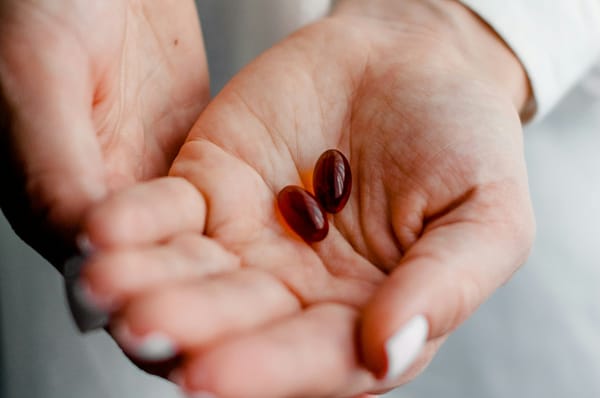 Hand holding vitamins