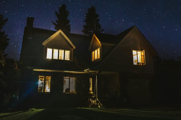 Picture of house at night with lights on